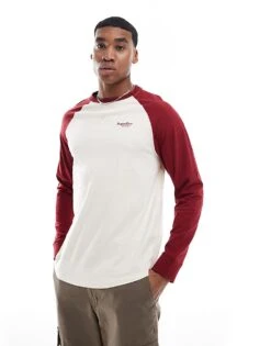 Superdry Essential Logo Baseball Long Sleeve Top In White Sand/rich Burgundy For Men
